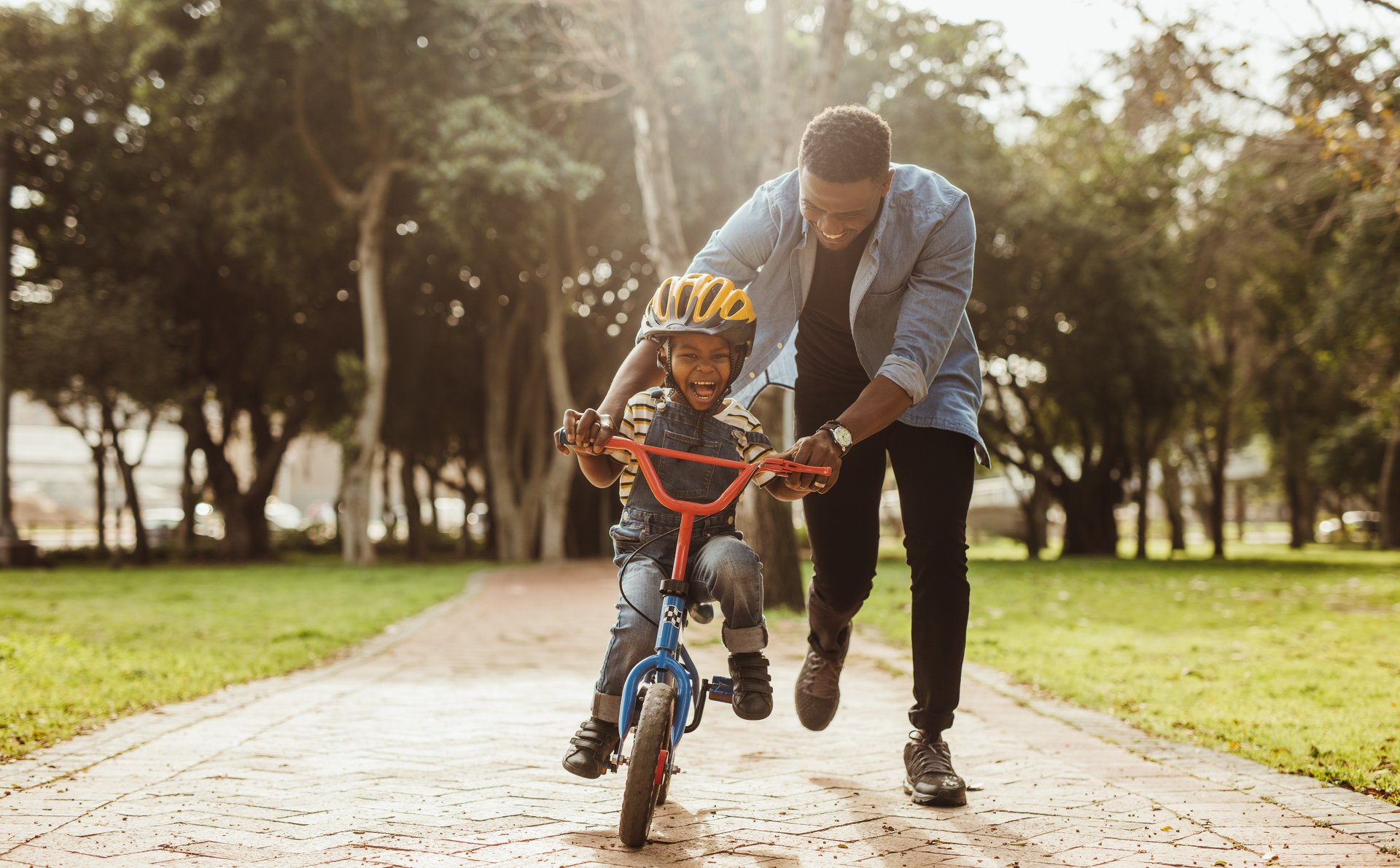 a father teaching his son to ride a bike